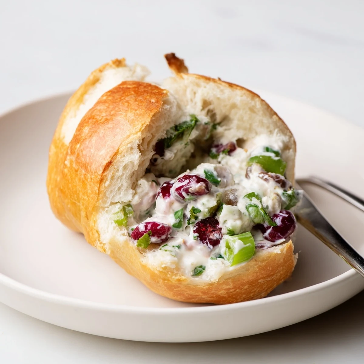 Creamy cranberry jalapeño dip rolled in warm, soft Philly rolls for parties.  