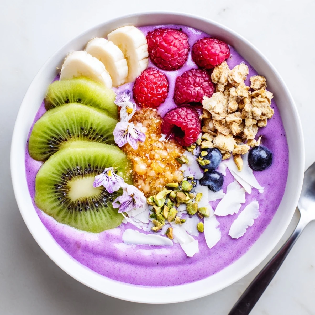 Vibrant smoothie bowls with pistachio and purple yam, topped with fresh fruits.  