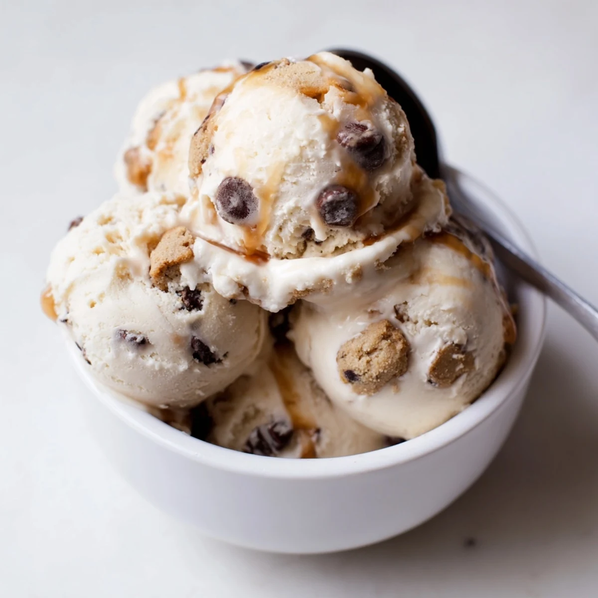 Indulgent cottage cheese ice cream topped with rich chocolate chip cookie dough for snacking.