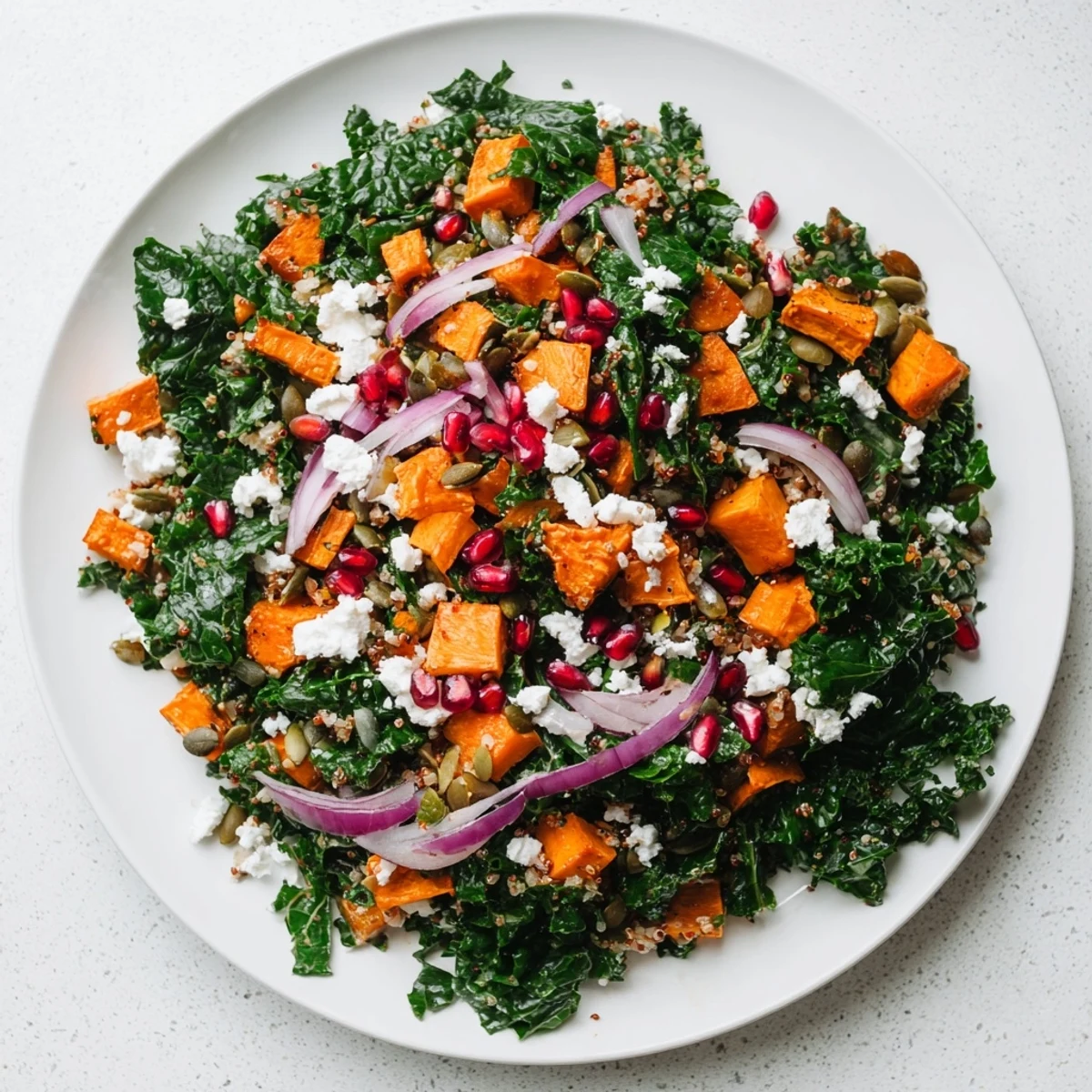 Vibrant Kale & Quinoa Salad features roasted sweet potatoes, a lemon dressing, and fluffy quinoa.