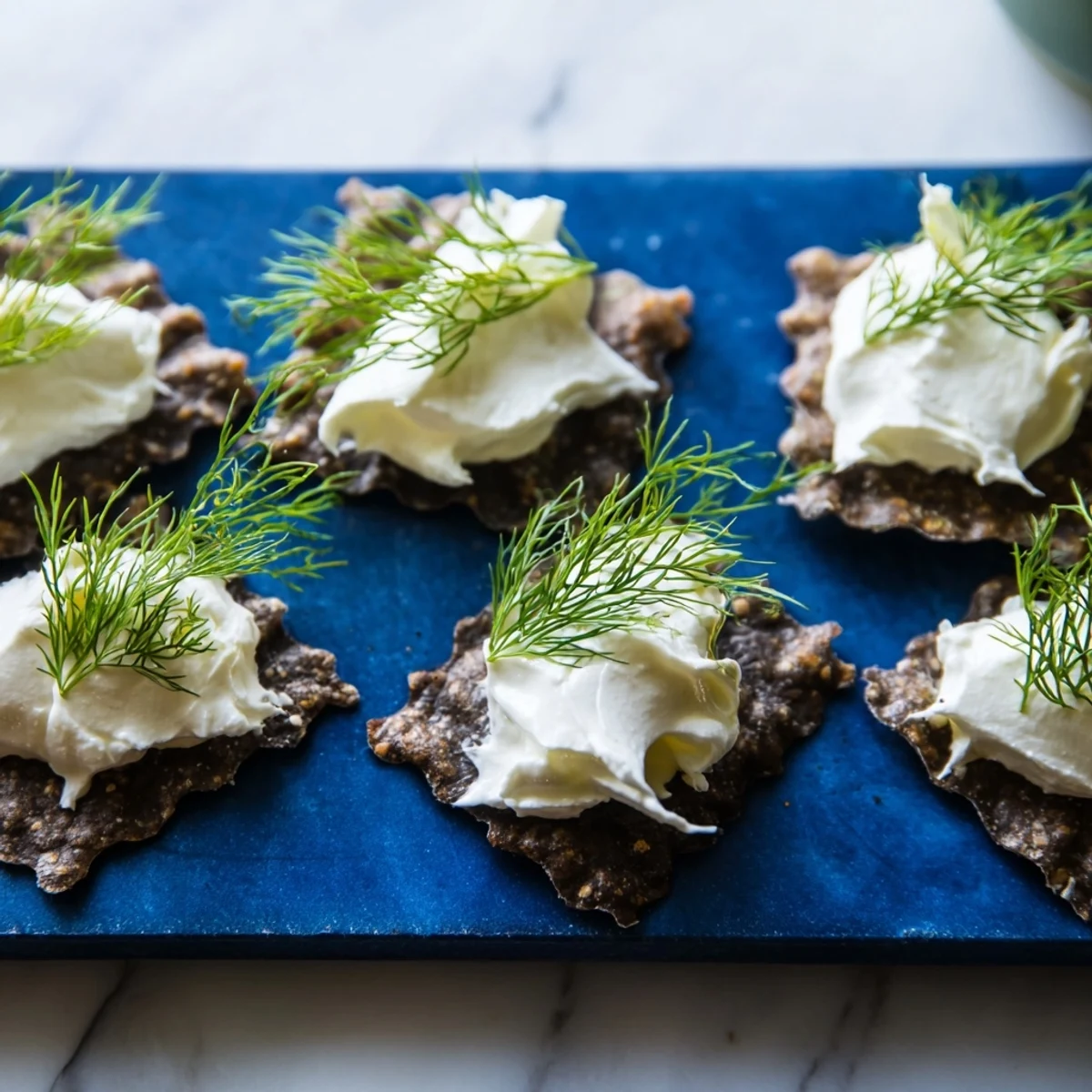 Imagine The Stormy Sea: a visually stunning appetizer with tangy goat cheese "waves" atop dark crackers.