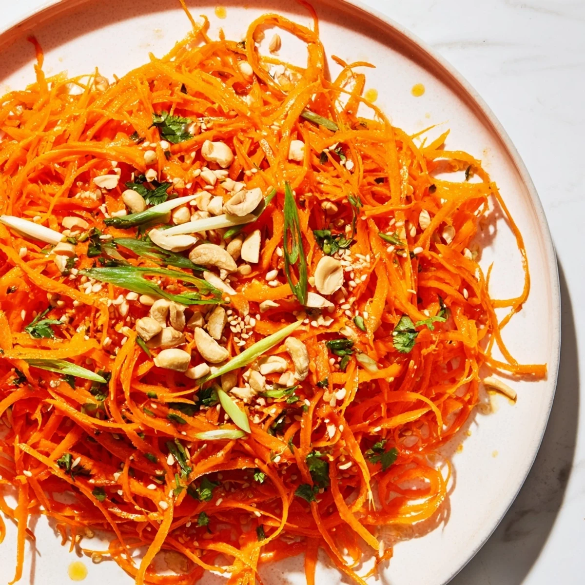 Freshly tossed Spicy Carrot Salad, featuring colorful carrots, ready to enjoy with a meal.