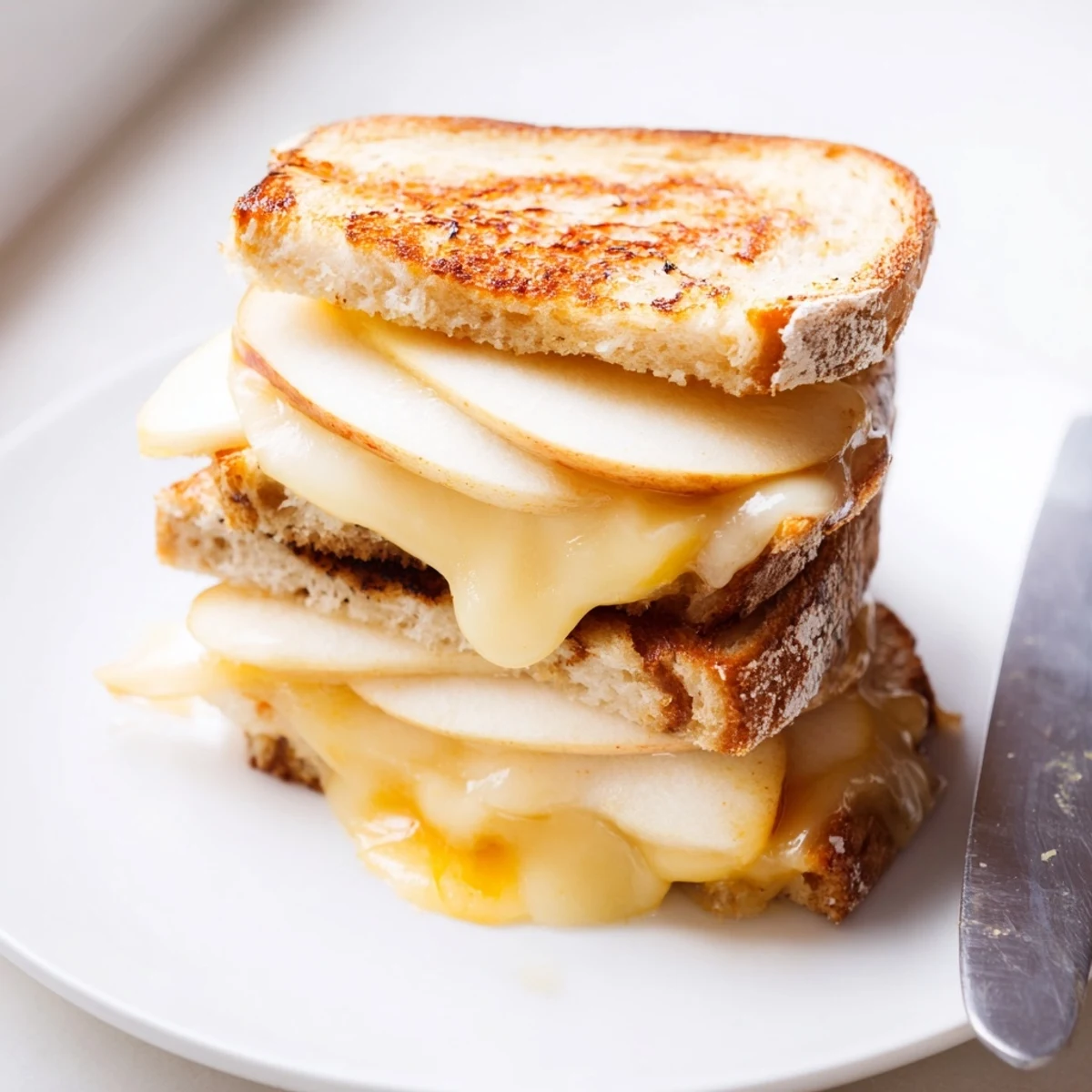 Melty smoked Gouda and crisp apple slices melt between golden-brown sourdough bread in this gourmet grilled cheese sandwich.