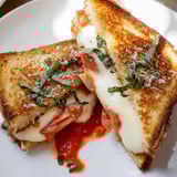 Golden, crispy Air Fryer Pizza Margherita Grilled Cheese oozing with cheese and tomato slices.