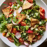 A close-up image of Fattoush Crunch Salad showing the bright, zesty sumac dressing and crunchy textures.