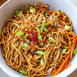 A close-up of a flavorful, glossy Asian Garlic Noodle Bowl, perfect for a quick dinner.