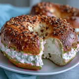 Greek yogurt bagels topped with everything seasoning, baked golden brown and ready to slice for breakfast.