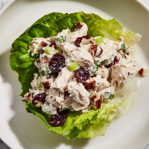 Festive Chicken Salad Cups, with juicy grapes and pecans, nestled in fresh, green lettuce cups.