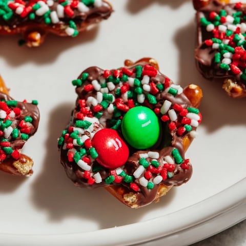 Warm, melty chocolate graces crispy Air Fryer Christmas Pretzel Bites, festively sprinkled for a tasty holiday dessert.