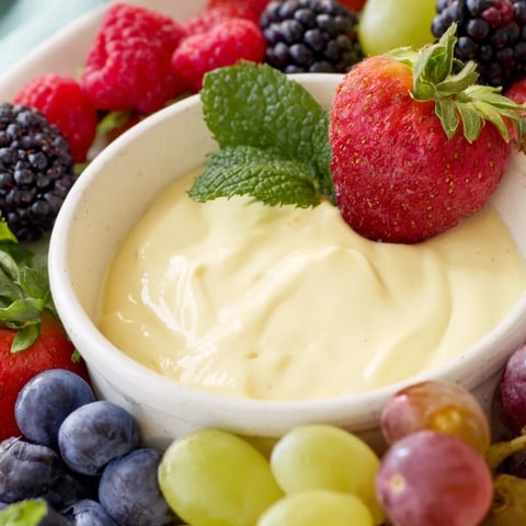 Mistletoe Kiss Berry Dip Board: a colorful holiday dessert board overflowing with fresh berries and creamy dip.