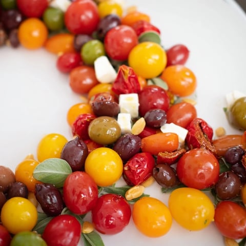 Festive Olive and Cherry Tomato Garland Board, bursting with olives, tomatoes, and creamy mozzarella.