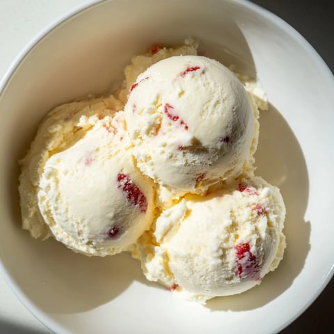 Cold, creamy cottage cheese ice cream swirled with fresh berries, perfect for a summer dessert.