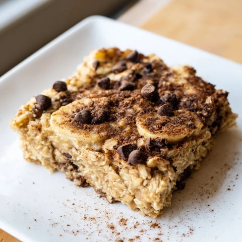 Golden-brown Baked Oats That Taste Like Cake, perfect for breakfast, with chocolate chips scattered on top.