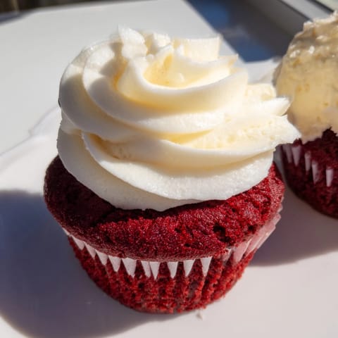 Decadent Red Velvet Cupcakes, baked until tender, topped with sweet, tangy frosting.