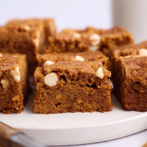 Deliciously spiced pumpkin muffin blondie bars cut into squares for a cozy dessert.  