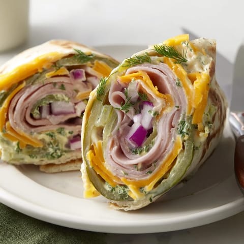 Flavorful Pickle-in-a-Blanket rolls, featuring creamy cheese and crunchy pickles.  