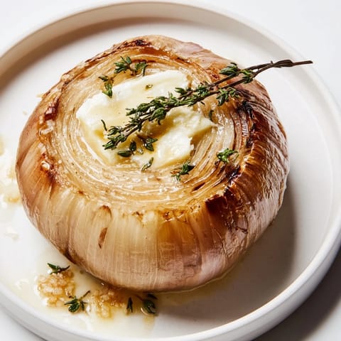 Tender, buttery Onion Boil: whole roasted Vidalia onions, filled with herbs, offering savory aromas.