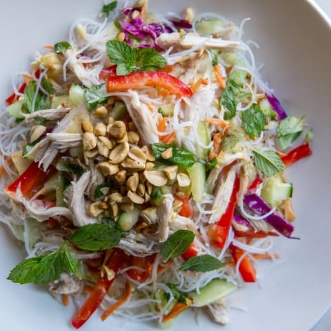 A fresh and flavorful bowl of Vietnamese Crunch Noodle Salad, ready to enjoy with a tangy dressing.