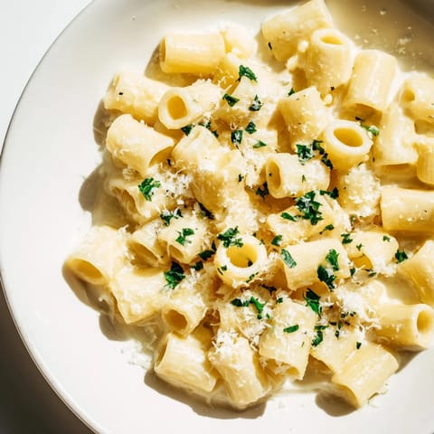 A close-up of the finished ditalini pasta, showcasing the creamy garlic sauce and Parmesan cheese.