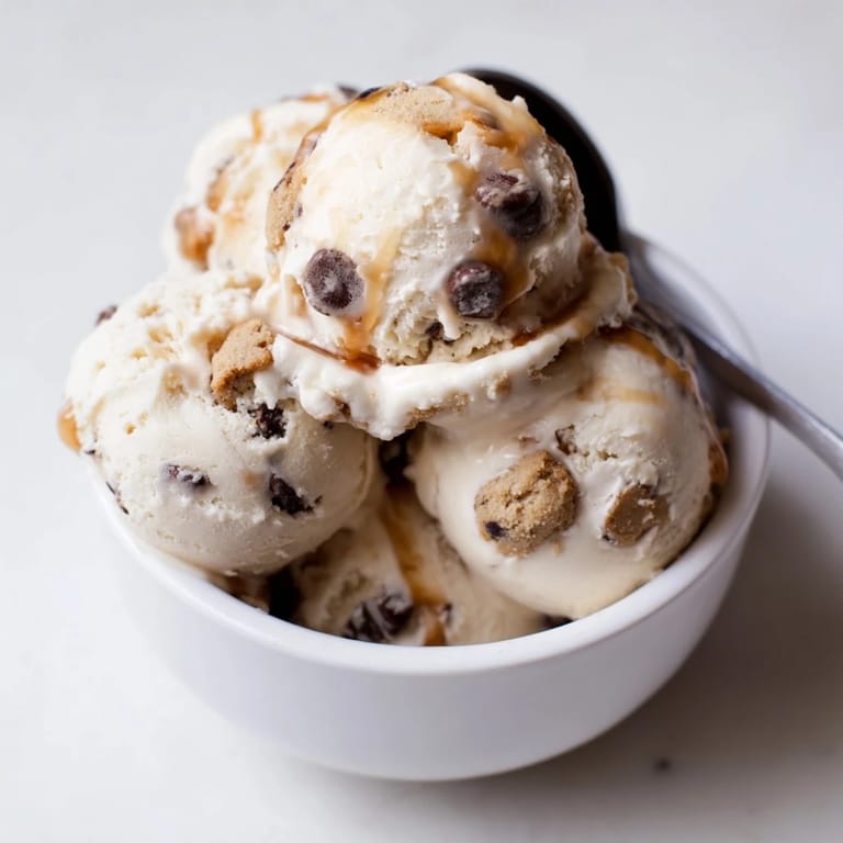 Indulgent cottage cheese ice cream topped with rich chocolate chip cookie dough for snacking.