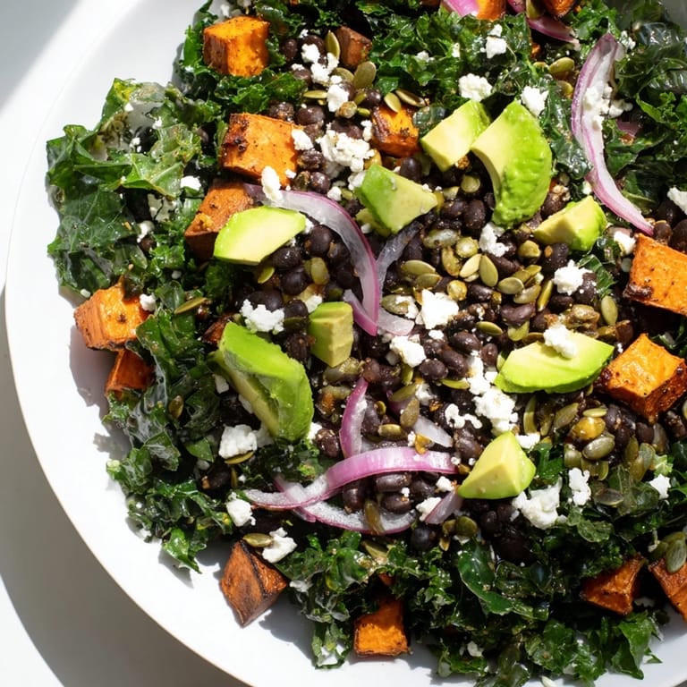 Close-up of a hearty Massaged Kale Salad, featuring roasted sweet potato, perfect for a healthy lunch.