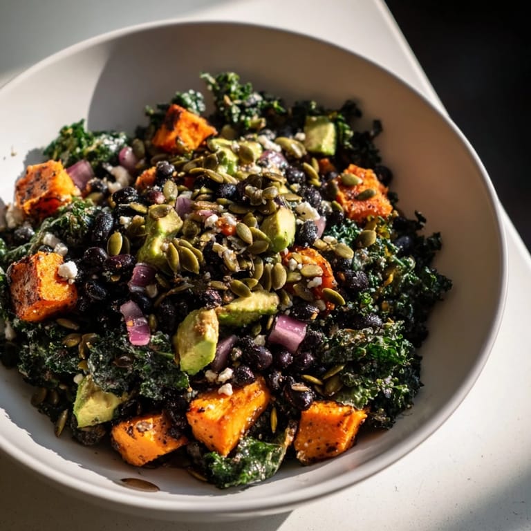 Vibrant image of a delicious Massaged Kale Salad loaded with sweet potato and lime dressing, ready to eat.