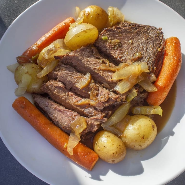 Fork-tender Pickle Brine Pot Roast, beautifully browned, surrounded by vibrant vegetables and potatoes for dinner.