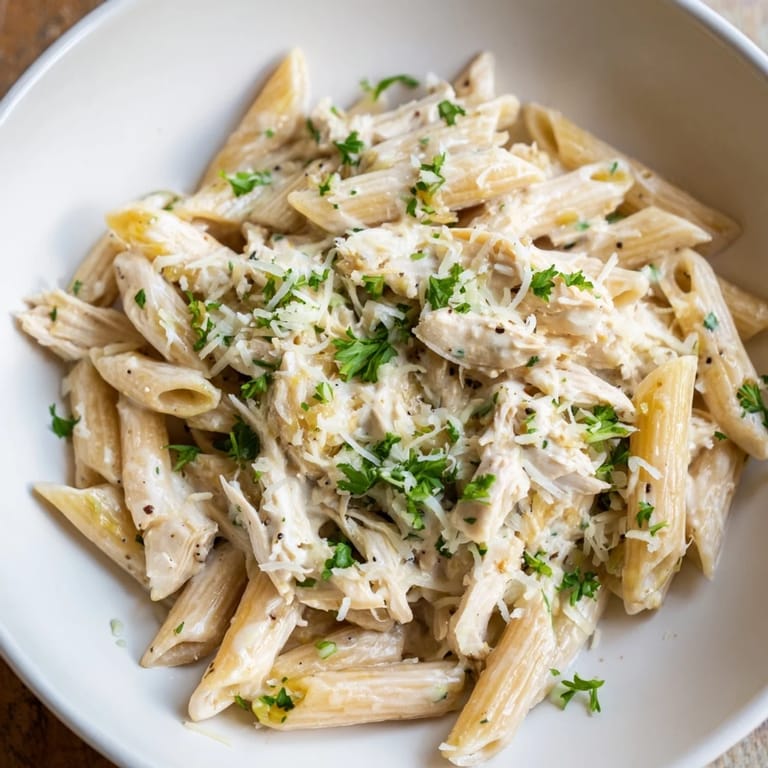 Enjoy a forkful of Tini's Creamy Chicken Pasta with penne, Parmesan, melted mozzarella and tender chicken pieces.