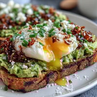 Chili Crisp Avocado Toast with poached egg, creamy avocado, and crunchy chili oil drizzle on toasted sourdough.